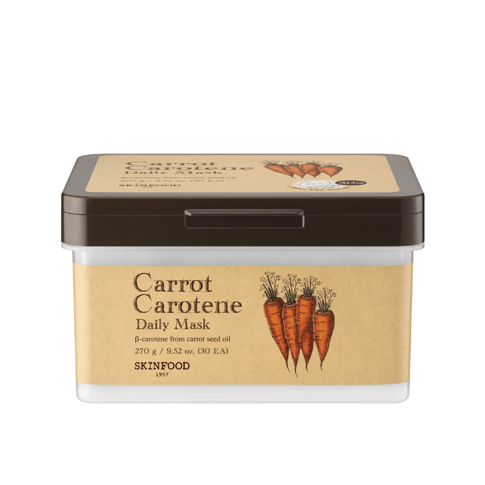 Opakowanie "Carrot Carotene Daily Mask" od SKINFOOD, zawierające 30 maseczek do twarzy. Produkt wzbogacony jest w β-karoten z oleju z nasion marchwi i zaprojektowany do codziennego użytku. Opakowanie jest solidne z etykietą w stylu vintage, która podkreśla marchew jako główny składnik.