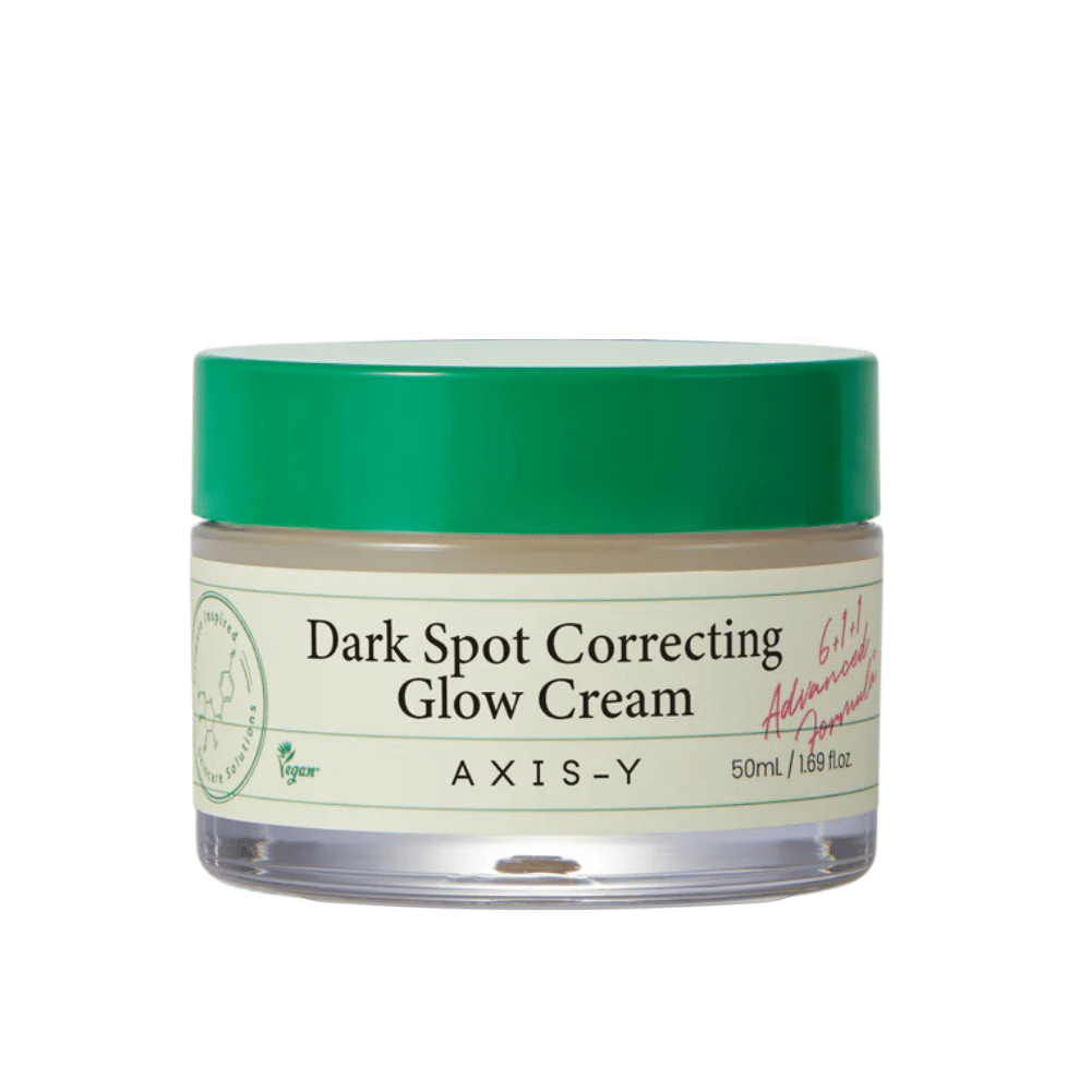 Słoik "AXIS-Y Dark Spot Correcting Glow Cream". Ten krem jest przeznaczony do korygowania ciemnych plam i nadawania skórze blasku. Opakowanie jest eleganckie z przezroczystym dołem i przyciągającą wzrok zieloną pokrywką.