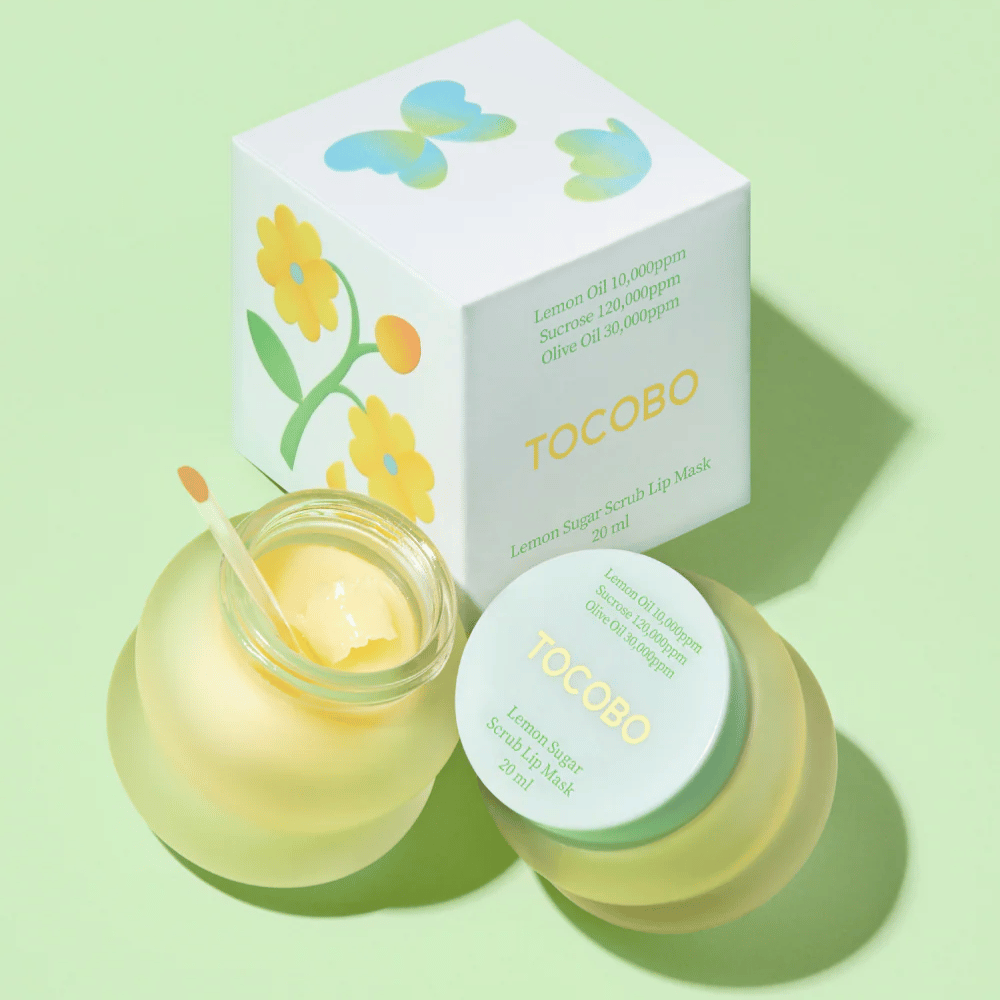 Tocobo Lemon Sugar Scrub Lip Mask razem z opakowaniem z kwiatowym wzorem na jasnozielonym tle.