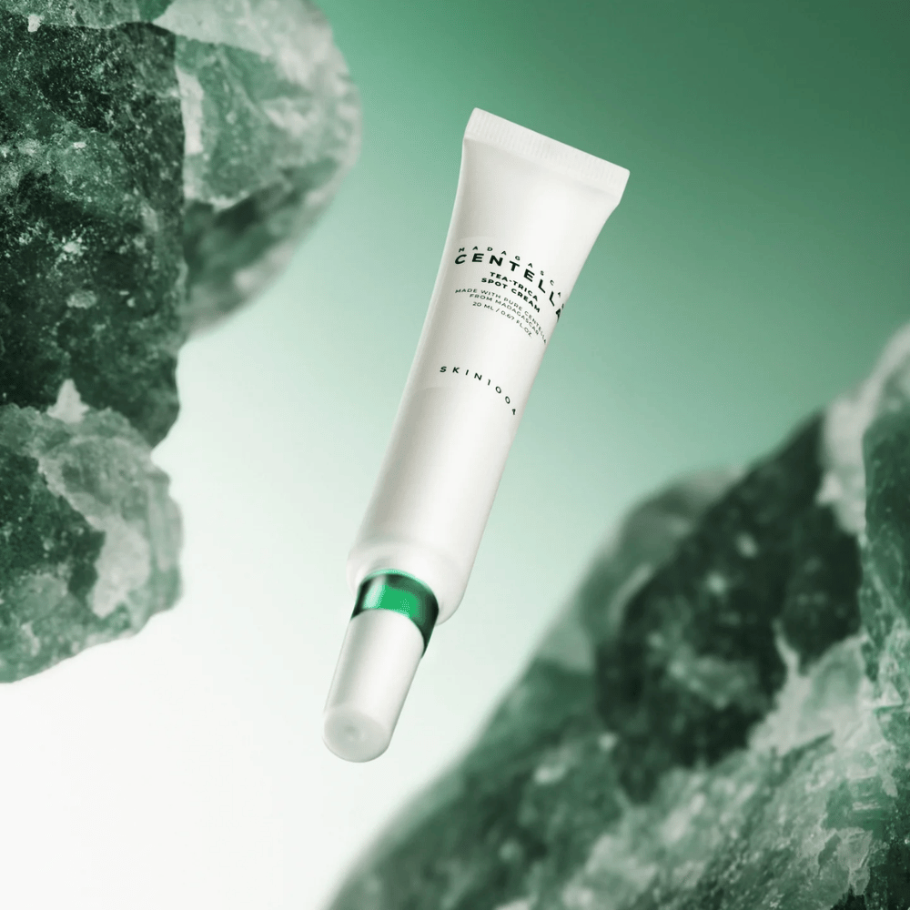SKIN1004 Madagascar Centella Tea-Trica Spot Cream 20 ml na trądzik i pryszcze, zdjęcie produktu z zielonym tłem i strukturą krystaliczną – łagodzący spot treatment z centellą asiatica i tea tree.