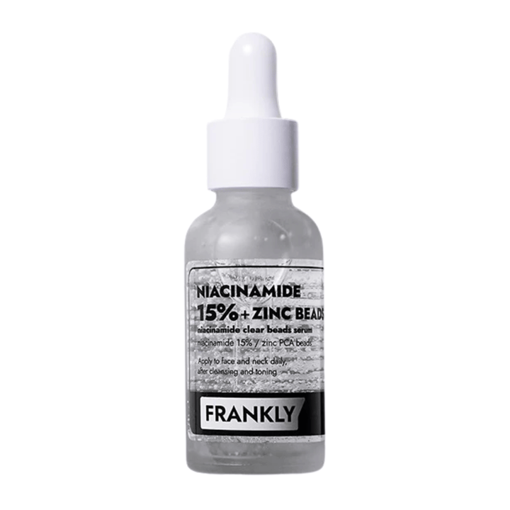 Produktbild av FRANKLY Niacinamide 15% + Zinc Beads Serum i glasflaska med pipett. Ett serum som balanserar, lugnar och förbättrar hudens klarhet.