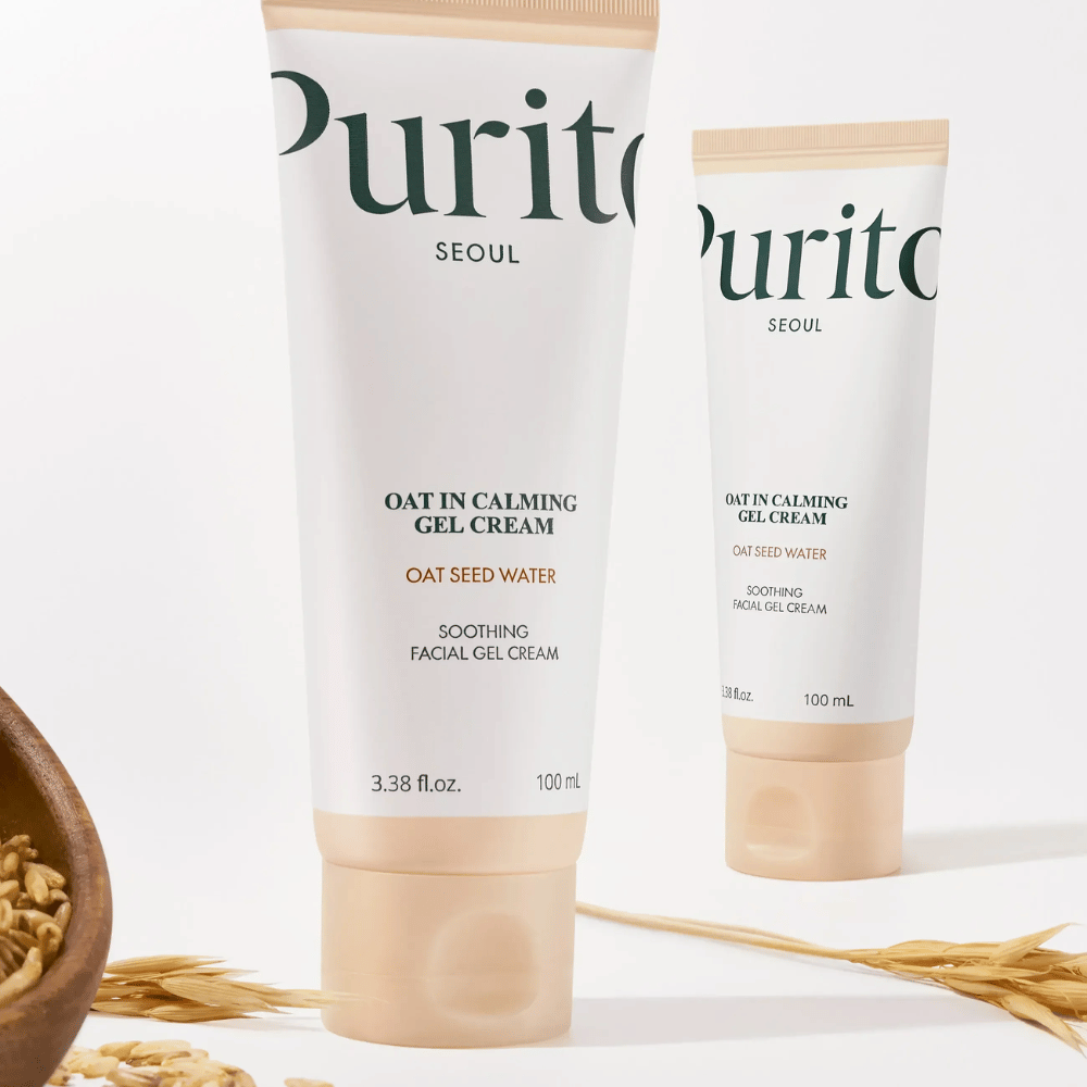 Purito Oat-In Calming Gel Cream w beżowej tubie, umieszczony z ziarnami owsa. Łagodzi wrażliwą skórę wodą owsianą i lekką żelową teksturą.