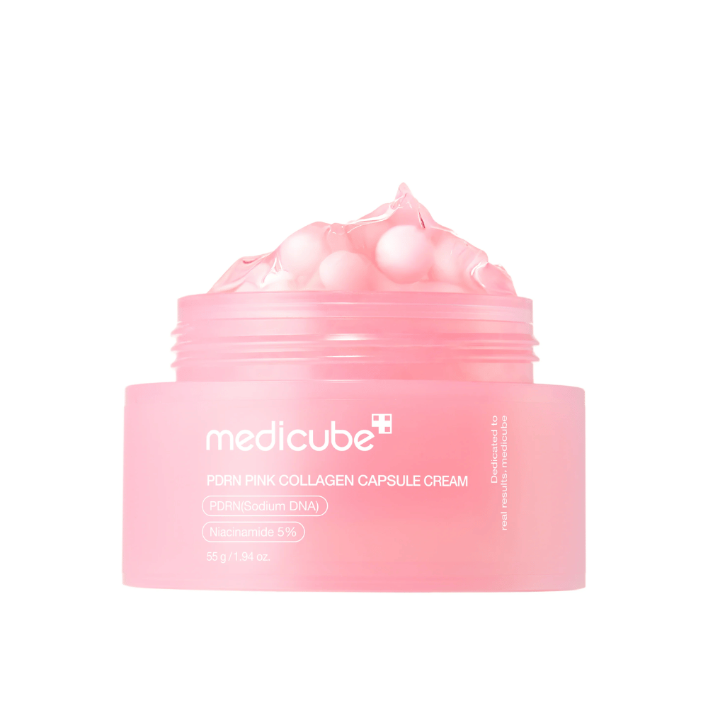 Zdjęcie produktu Medicube PDRN Pink Collagen Capsule Cream z widocznymi różowymi kapsułkami w przezroczystym różowym słoiku, zaprojektowanym do nawilżania i wyrównywania kolorytu skóry.