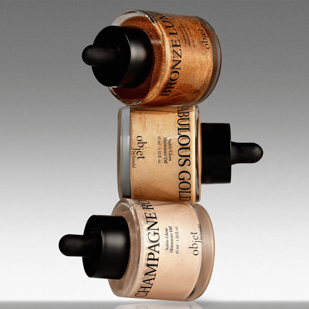 Objet by KUNDAL Satin Glow Shimmer Oil w odcieniu Bronze Lumière, Fabulous Gold i Champagne Rose – połyskujące olejki do ciała z rozświetlającym wykończeniem.